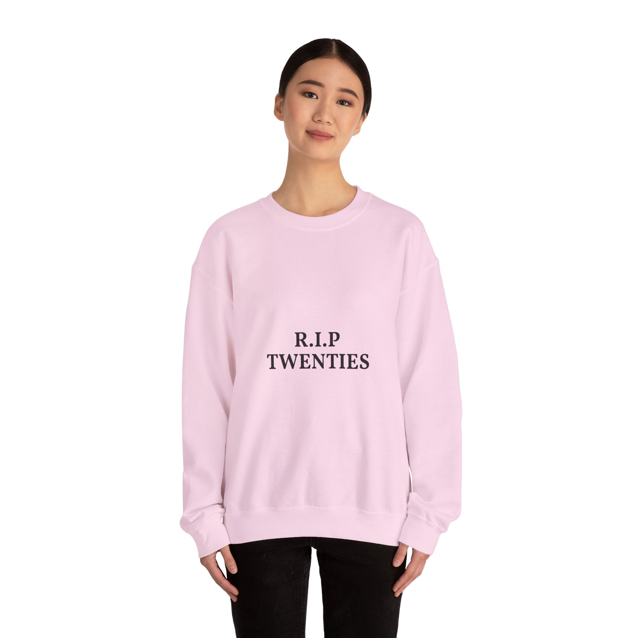 Person wearing a pink sweatshirt with a green pepper design on a white background