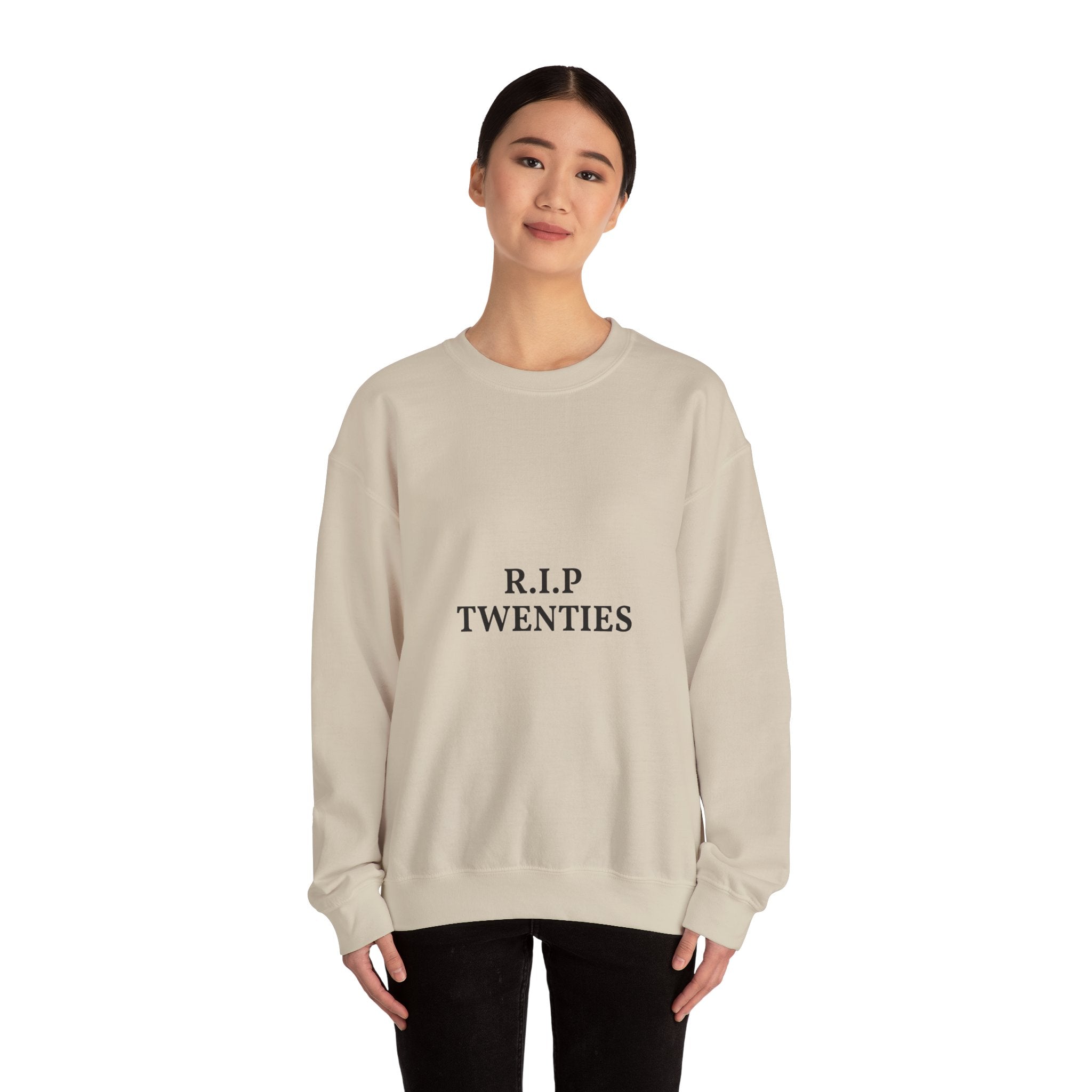 Person wearing a beige sweatshirt with a logo on a white background