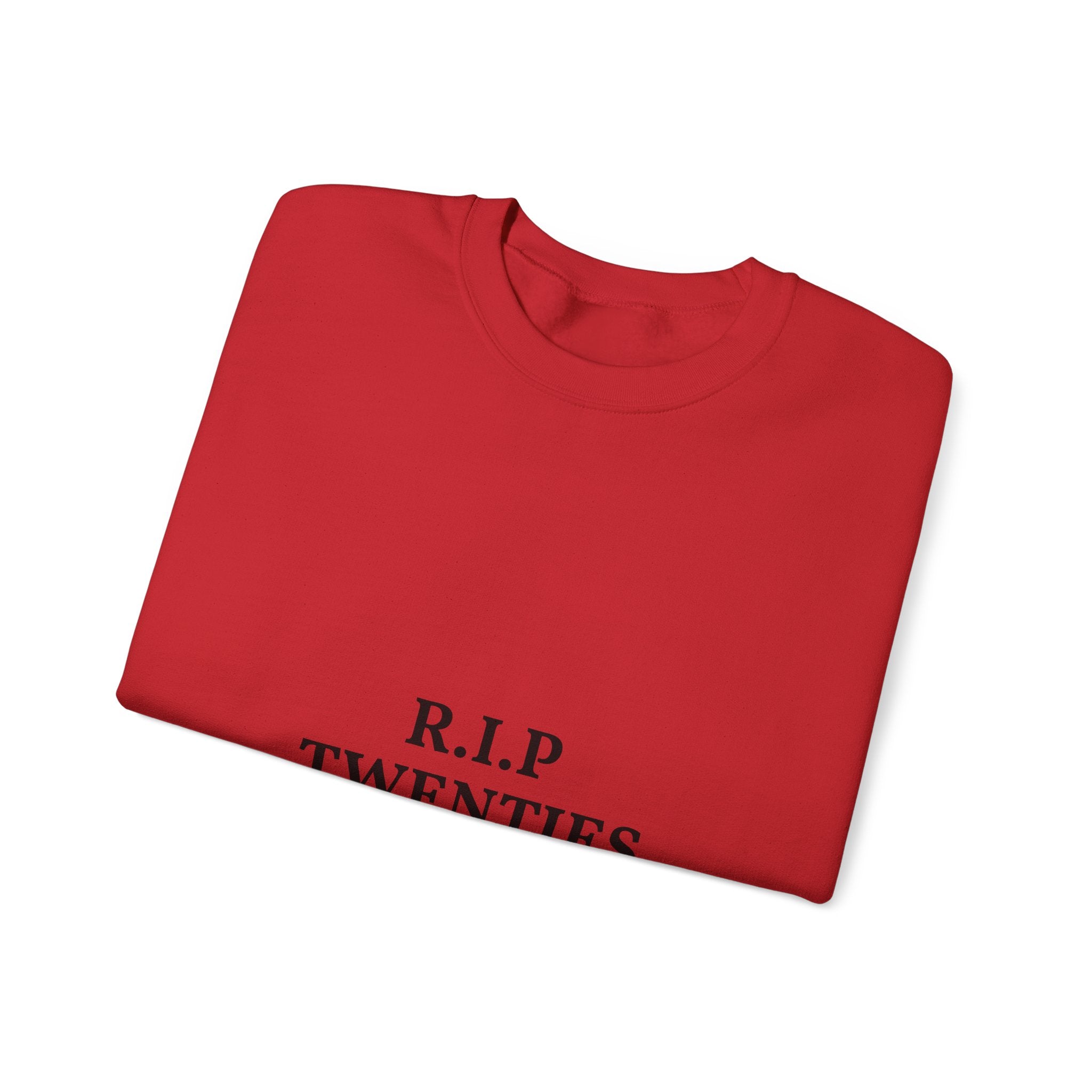 Folded red shirt with 'R.I.P. TWENTIES' text on a white background